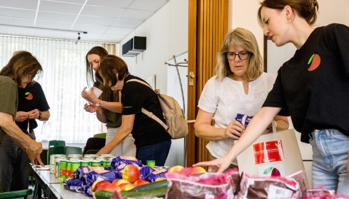 Das Obstkäppchen-Team mit ehrenamtlichen Helferinnen und Helfern beim Packen der Lebensmitteltüten. Foto: Roland Meurer